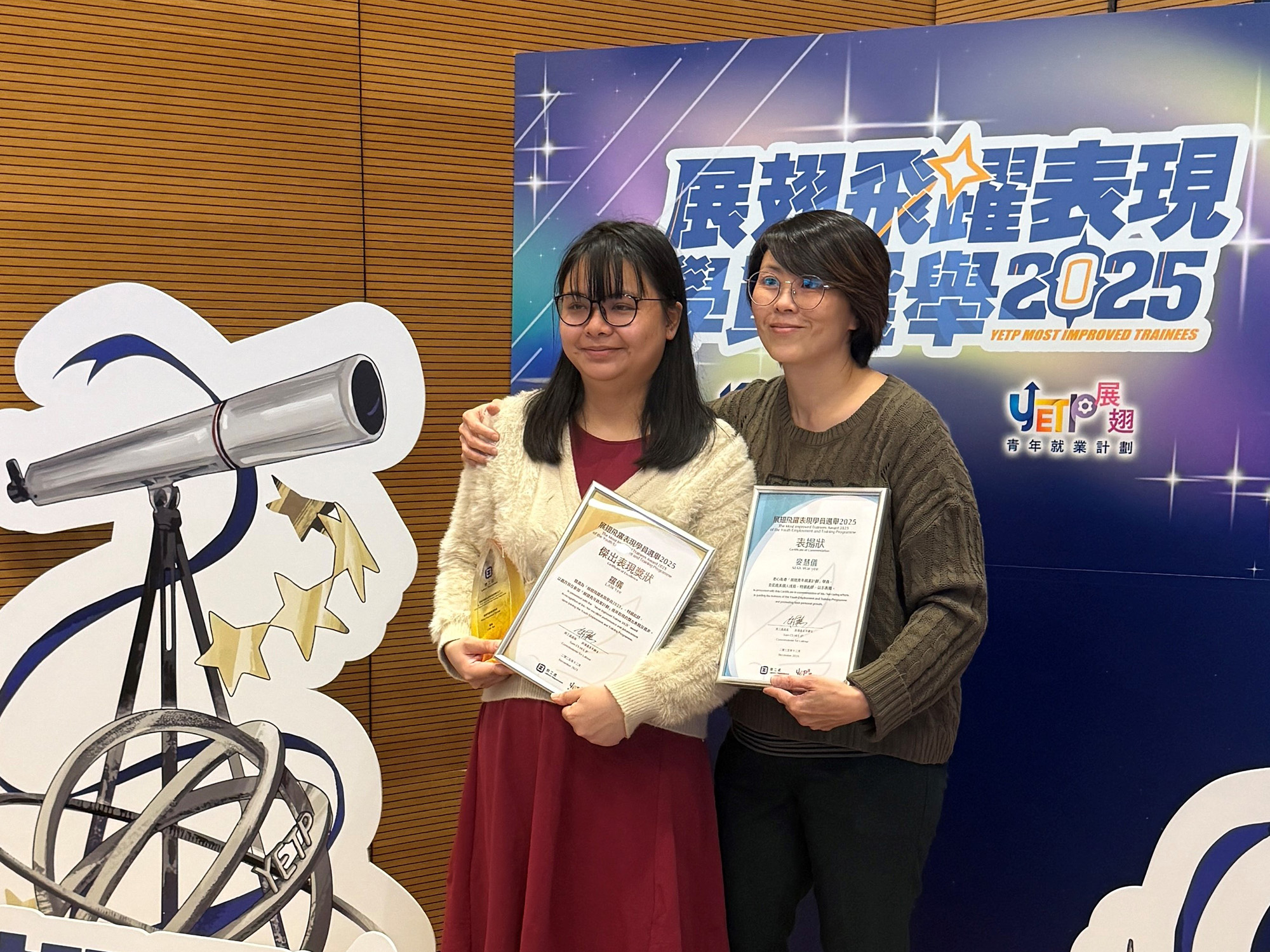 Awardees with guests, family and friends, employers and service providers taking photos together