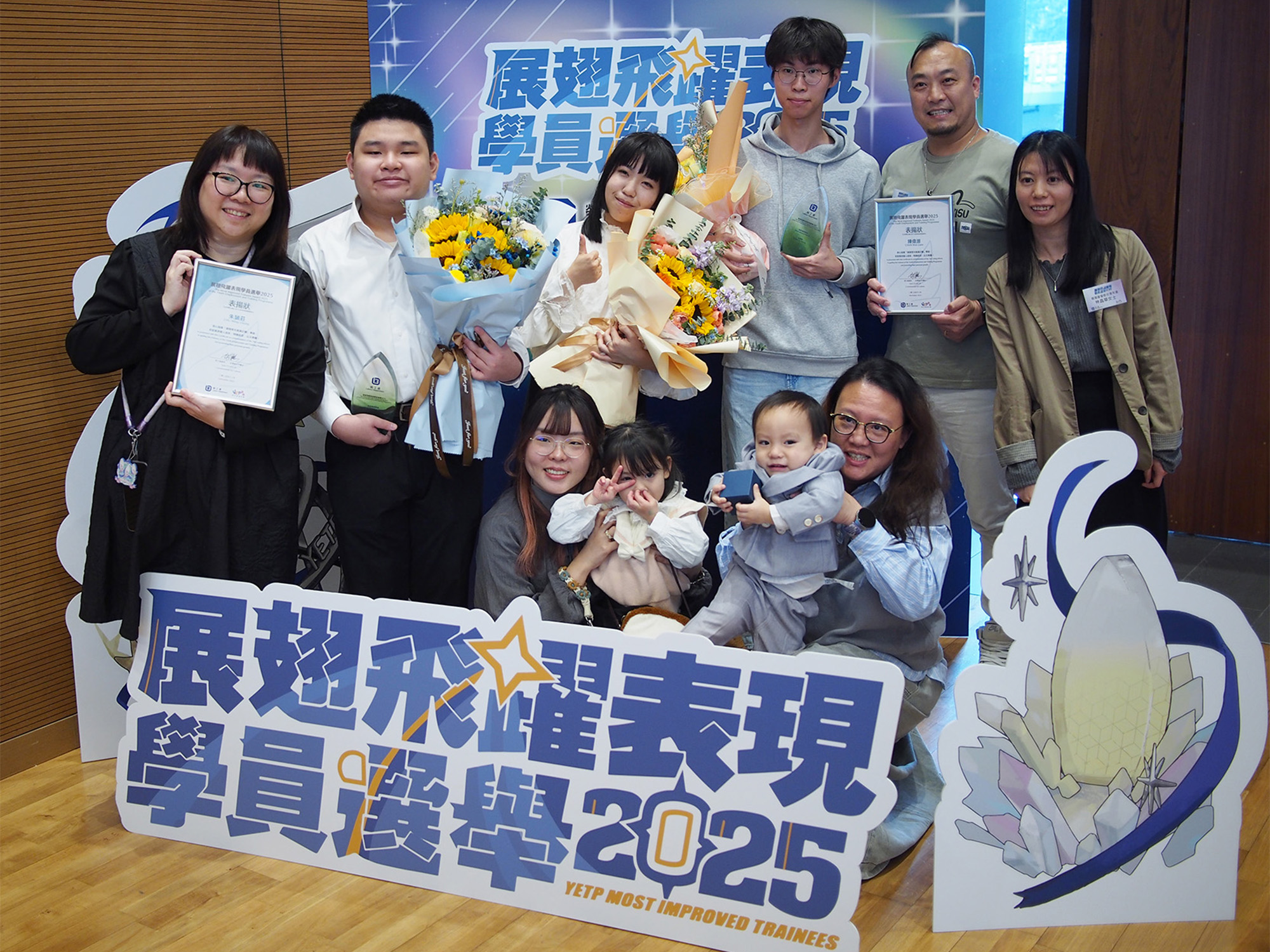 Awardees with guests, family and friends, employers and service providers taking photos together